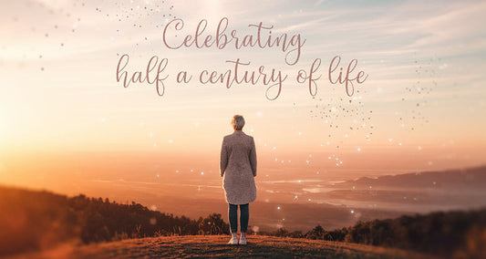 Decoration feature image of a person stood on a hill looking out over the country during sunset contemplating life at 50